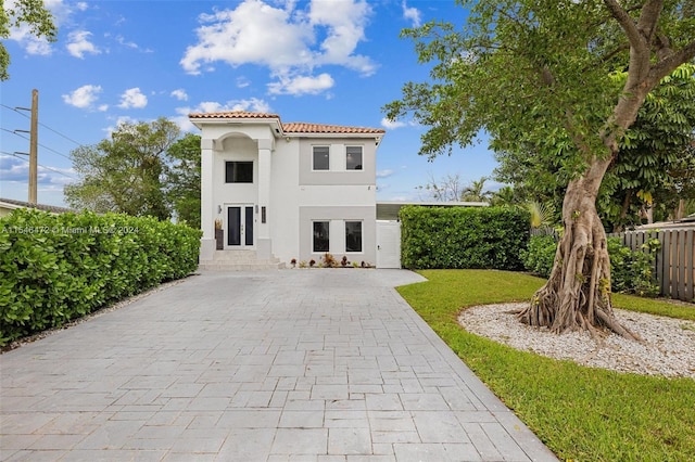 mediterranean / spanish house featuring a front lawn