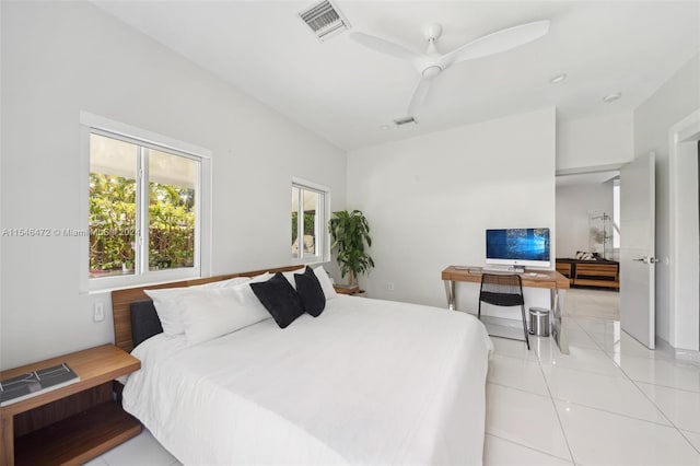 tiled bedroom featuring ceiling fan