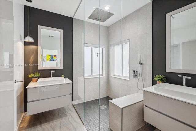 bathroom featuring vanity, tile patterned flooring, and tiled shower