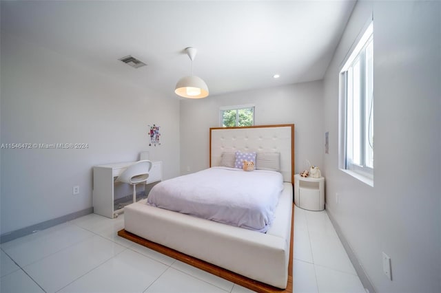 tiled bedroom featuring multiple windows