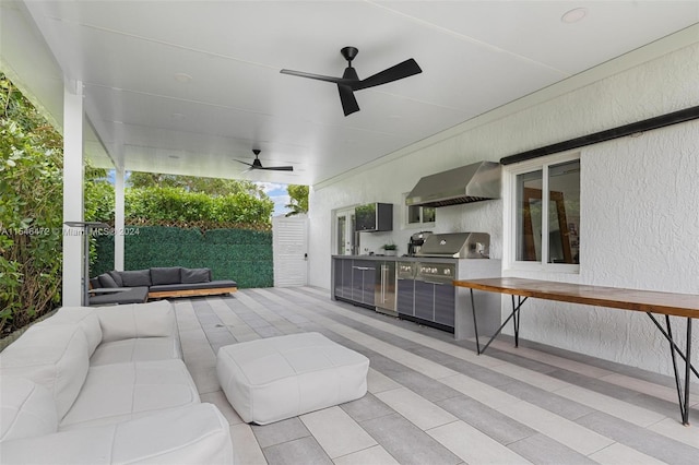 view of patio / terrace with an outdoor hangout area, grilling area, ceiling fan, and exterior kitchen