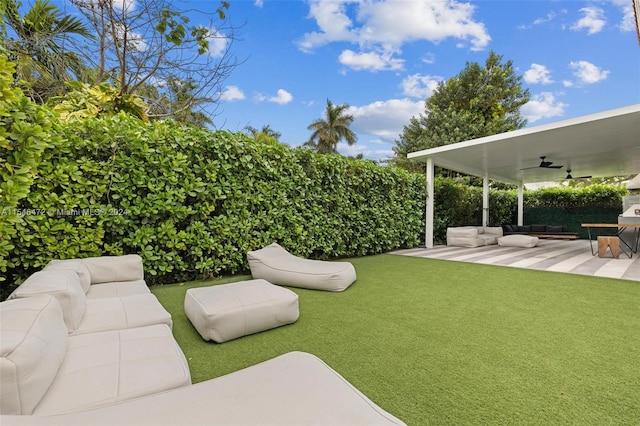 view of yard with ceiling fan, outdoor lounge area, and a patio