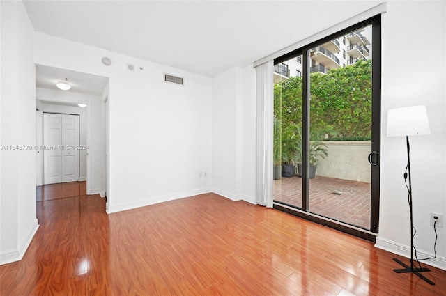 spare room featuring light hardwood / wood-style floors