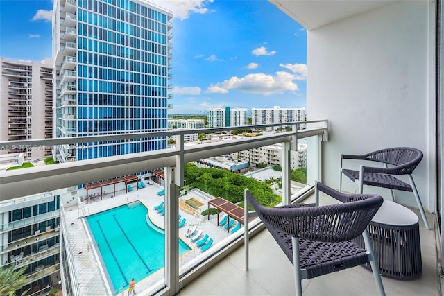 balcony featuring a community pool