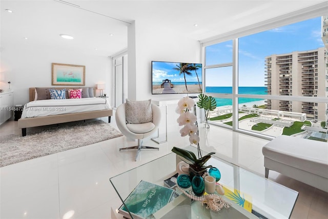 bedroom featuring a wall of windows and a water view