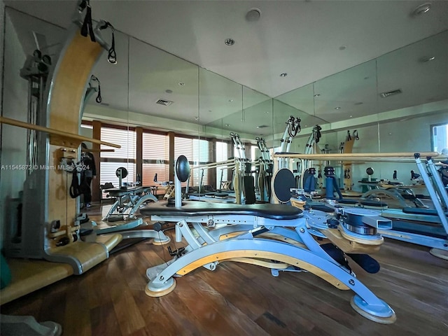 exercise room with dark hardwood / wood-style flooring