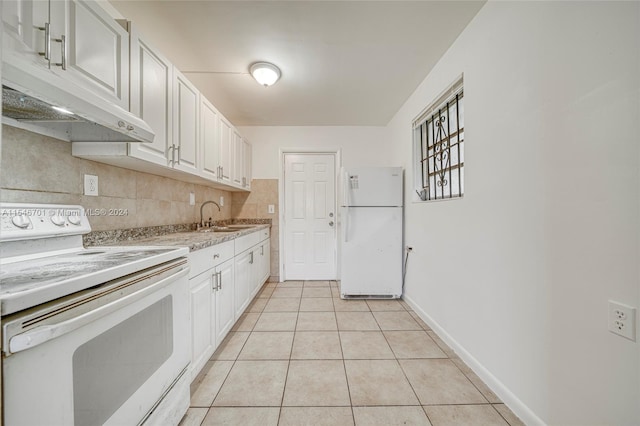 kitchen featuring white appliances, tasteful backsplash, white cabinetry, sink, and light tile floors