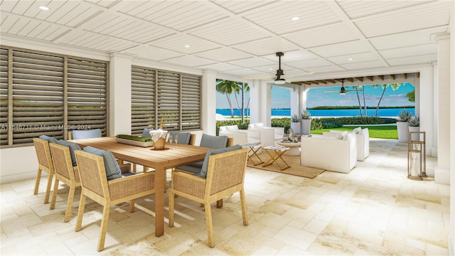 sunroom / solarium with ceiling fan and a water view