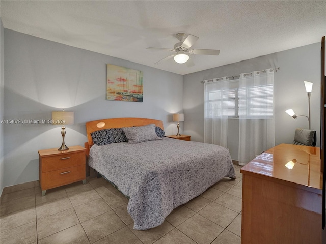 tiled bedroom with a textured ceiling and ceiling fan