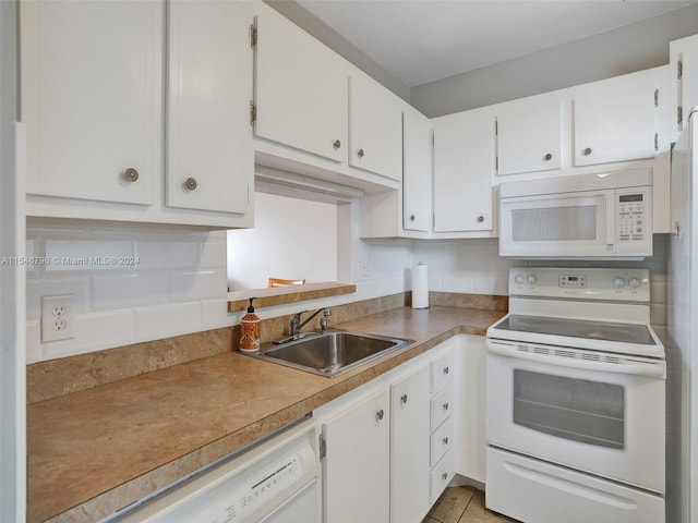 kitchen with white appliances, white cabinets, sink, and light tile flooring