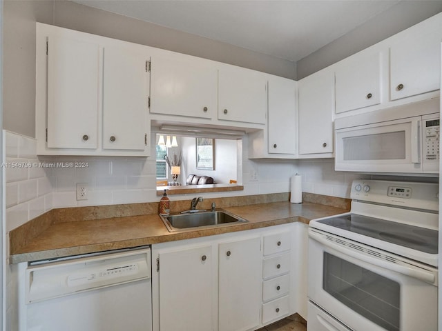 kitchen with white appliances, white cabinets, backsplash, and sink