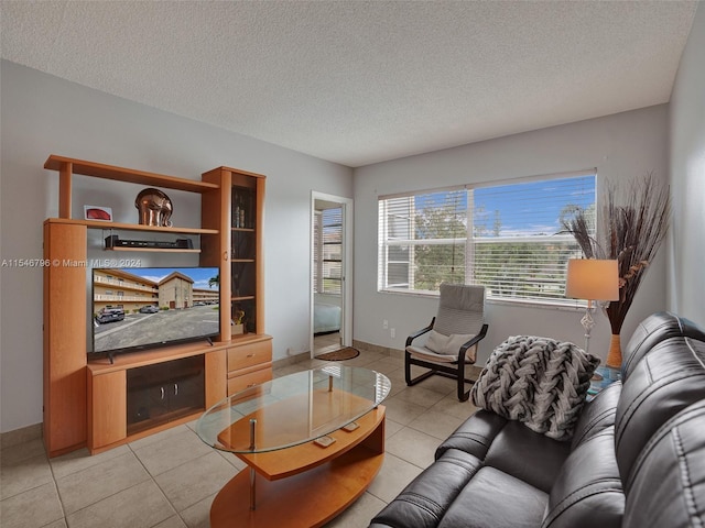 living room featuring a textured ceiling and light tile flooring