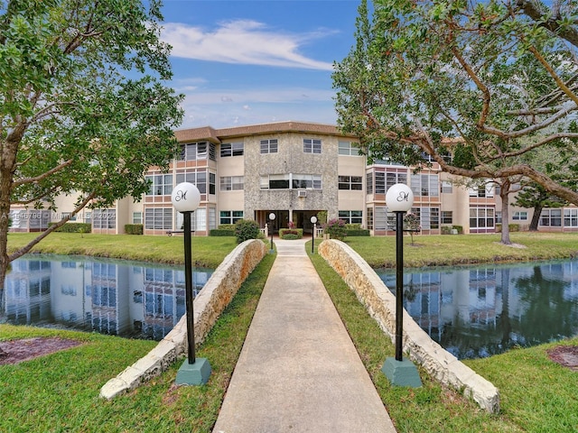 view of nearby features featuring a lawn and a water view