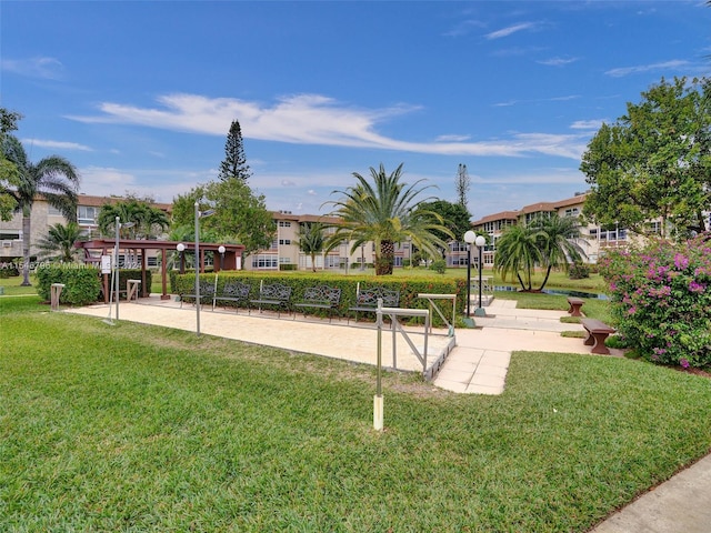 surrounding community featuring volleyball court and a lawn