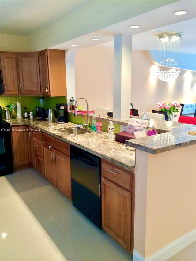 kitchen featuring black dishwasher, light stone countertops, sink, and light tile floors