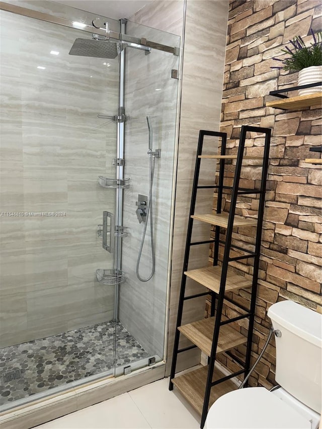 bathroom with walk in shower, tile patterned flooring, and toilet