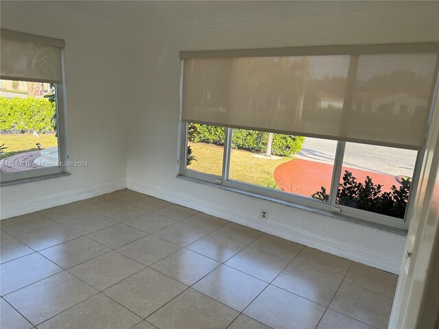 tiled empty room with plenty of natural light