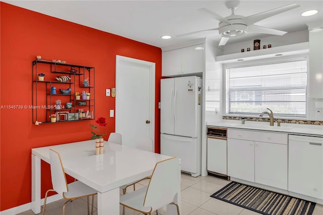 kitchen featuring white appliances, ceiling fan, light tile floors, sink, and white cabinetry