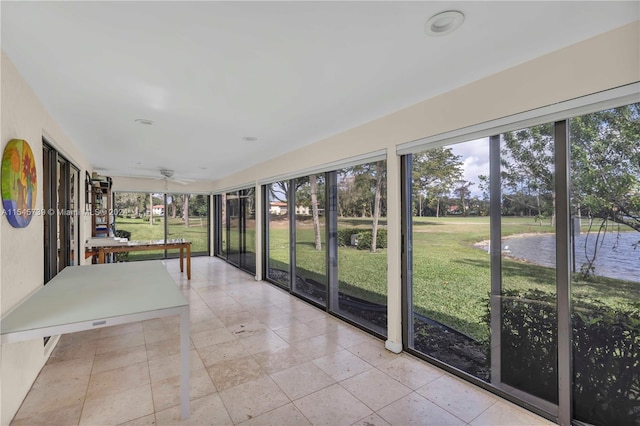 unfurnished sunroom with ceiling fan