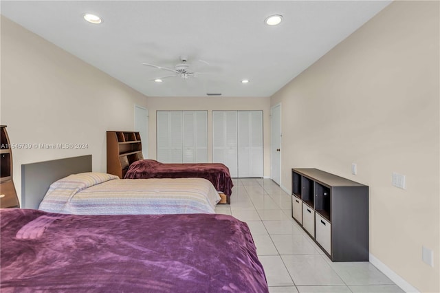 tiled bedroom with multiple closets and ceiling fan