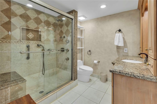 bathroom featuring vanity, tile flooring, a shower with door, and toilet