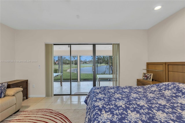 tiled bedroom featuring a water view and access to exterior