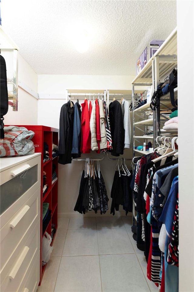 walk in closet featuring light tile flooring