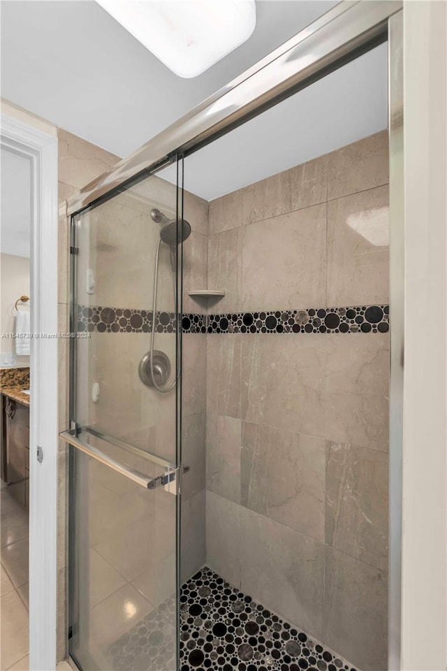 bathroom featuring a shower with shower door