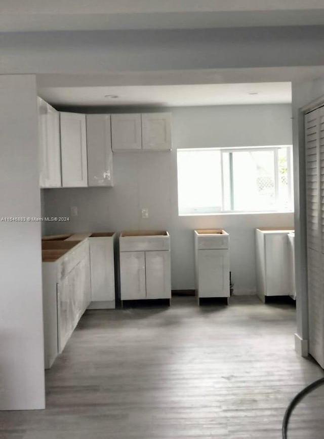 kitchen featuring light hardwood / wood-style flooring and white cabinetry