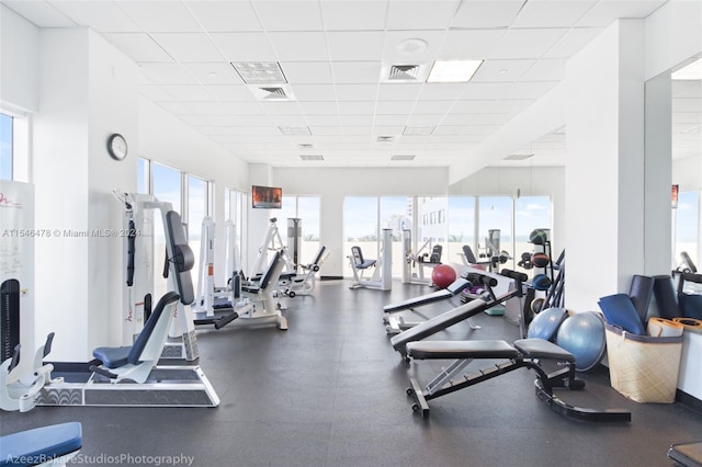 exercise room featuring a paneled ceiling