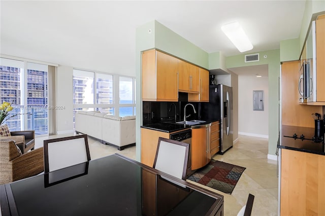 kitchen featuring light tile floors, backsplash, sink, and stainless steel appliances