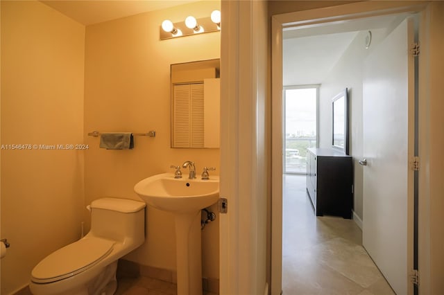 bathroom with tile floors and toilet