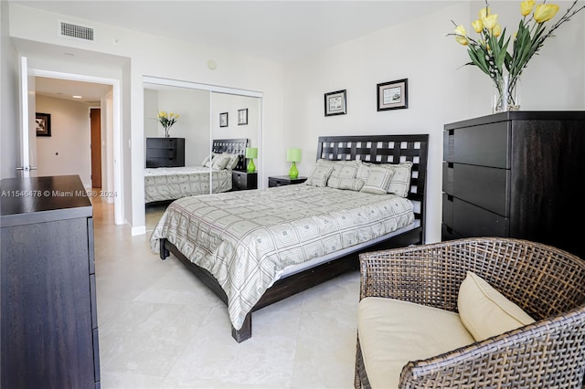 bedroom with light tile floors and a closet