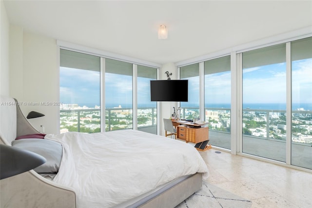 bedroom with access to outside, multiple windows, and floor to ceiling windows