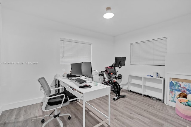 home office with light hardwood / wood-style floors