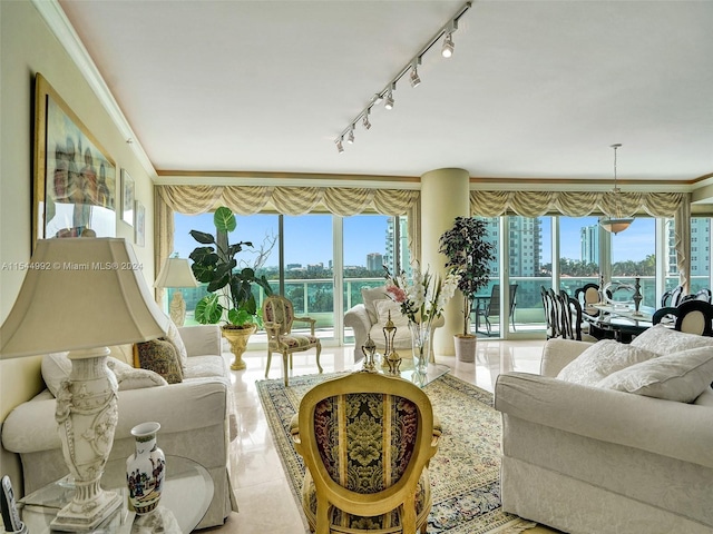 tiled living room featuring a water view, crown molding, rail lighting, and a wealth of natural light