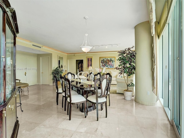 tiled dining space featuring rail lighting, a wealth of natural light, and ornamental molding