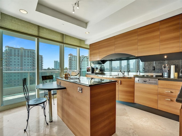 kitchen with rail lighting, dishwashing machine, backsplash, light tile flooring, and a center island