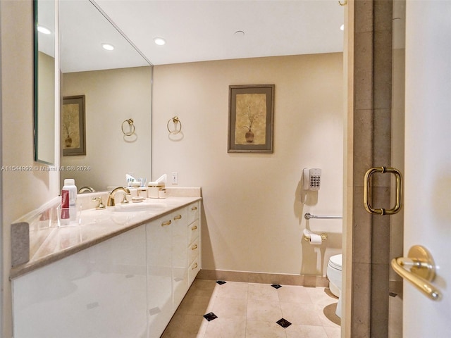 bathroom with tile flooring, oversized vanity, and toilet