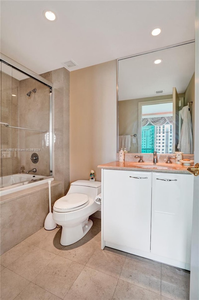 bathroom featuring toilet, tile floors, and vanity