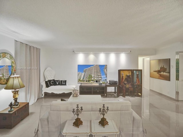 living room with light tile floors and a textured ceiling