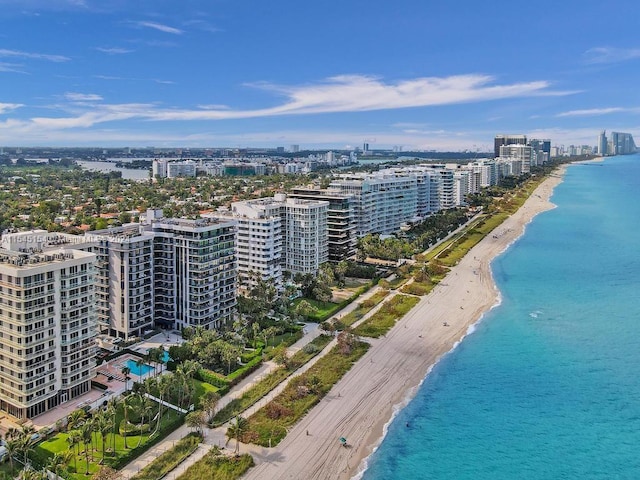 drone / aerial view featuring a water view and a beach view