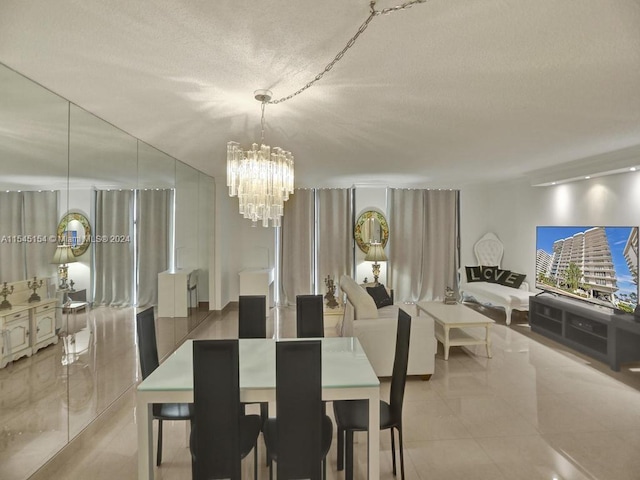 dining space featuring light tile floors and a chandelier