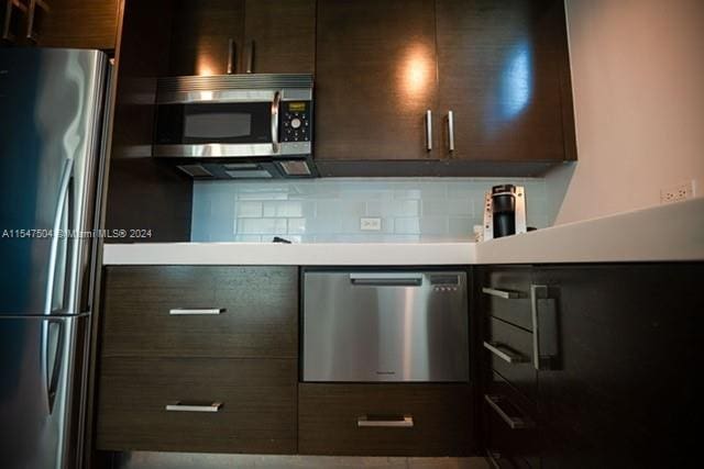 kitchen with backsplash, stainless steel appliances, and dark brown cabinets