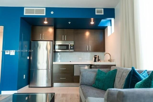 kitchen featuring tasteful backsplash, appliances with stainless steel finishes, and sink