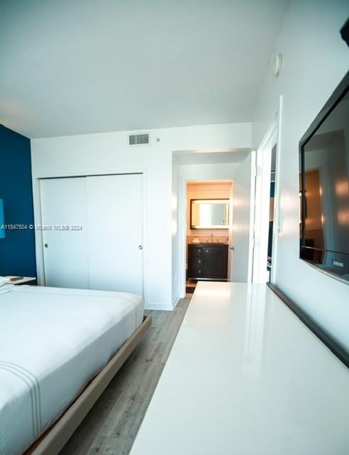 bedroom with a closet and light wood-type flooring