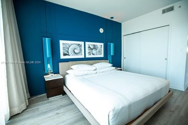 bedroom featuring a closet and light wood-type flooring