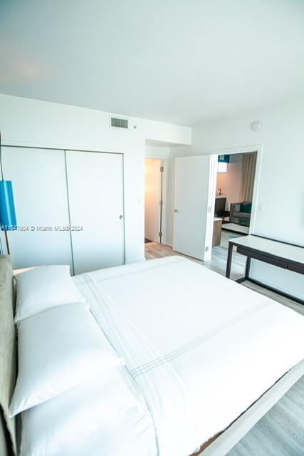 bedroom with a closet and light hardwood / wood-style flooring