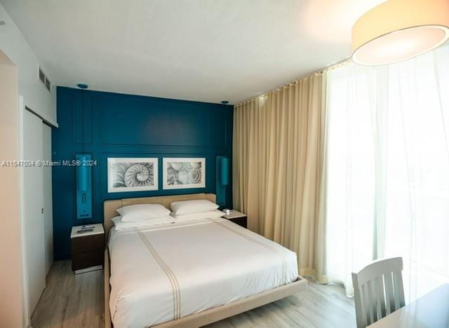 bedroom with pool table and light hardwood / wood-style flooring