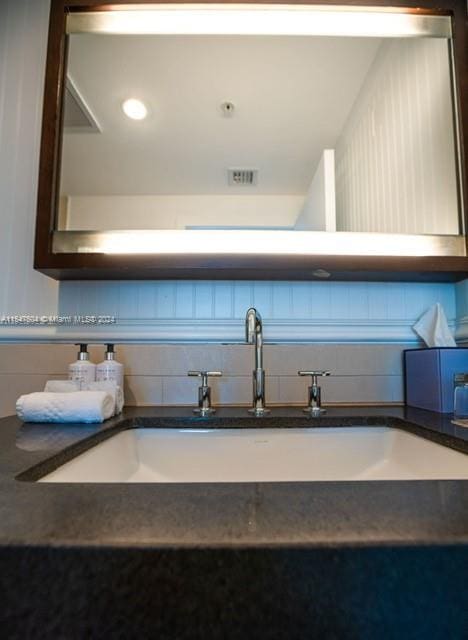 bathroom featuring backsplash and sink